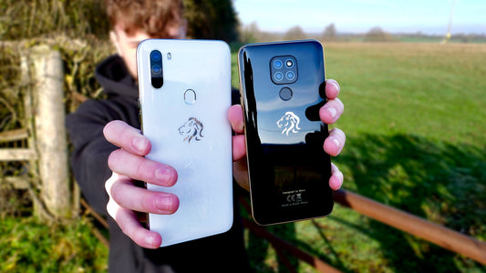 Person holding two Mara smartphones, white Mara Z1 and black Mara X1, with outdoor background
